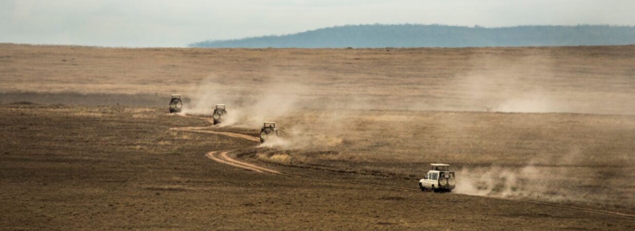 Safari jeeps crossing Serengeti, Tanzania, Africa