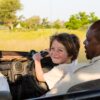 smiling 6 year old boy steering safari vehicle, Botswana